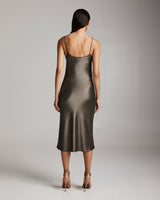 Back view of a model wearing a sage midi slip dress