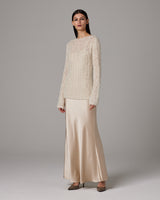 Model wearing Open Mesh Boatneck Sweater in ivory with satin skirt