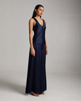 Model wearing a navy silk palazzo pants and tank top outfit