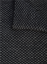 Close-up of the textured fabric of the Lineas Fringe Scarf in black and grey.