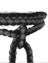 Close-up of a hand-braided wool rope belt in black and grey colors.