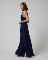 Model wearing a navy Crinkle Chiffon Palazzo Jumpsuit from the side, showcasing the palazzo leg design.