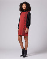 Model wearing a sleeveless red mini dress with black accents and diamond patterns.