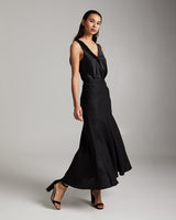 Model wearing a black Linen Spiral Skirt with a black top and heels