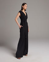 Model wearing a black V Neck Jumpsuit with pockets