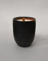 Hand-poured ceramic vessel candle in black with a wooden wick