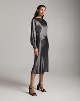 Model wearing a Bias Midi Skirt in Silk Charmeuse, styled with a long-sleeve blouse.