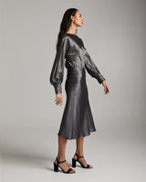 Model wearing a Bias Midi Skirt in Silk Charmeuse, styled with a matching top and heels.