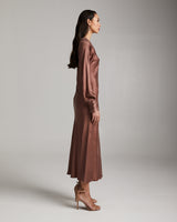 Model wearing a mauve bare shoulder dress in Cupro, side view