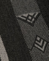 Close-up of the Wide Diagonal Alpaca Wrap fabric showing intricate patterns in grey and black.