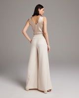 Model wearing high waist wide trousers from the back, showcasing the fit and style.