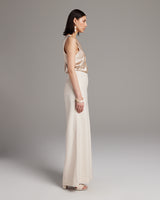 Model wearing high waist wide trousers in pearl color, side view