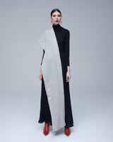 Model wearing a Chevron scarf in light gray over a black dress with red shoes