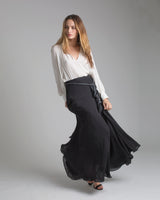 Model wearing a black skirt with a grey/black rope belt