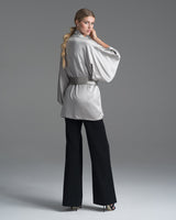 Model wearing a silver silk kimono with a matching belt, facing away from the camera