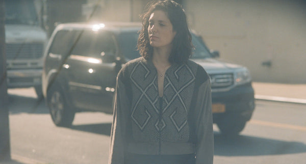 Erin Mazursky standing on a street, wearing a patterned sweater