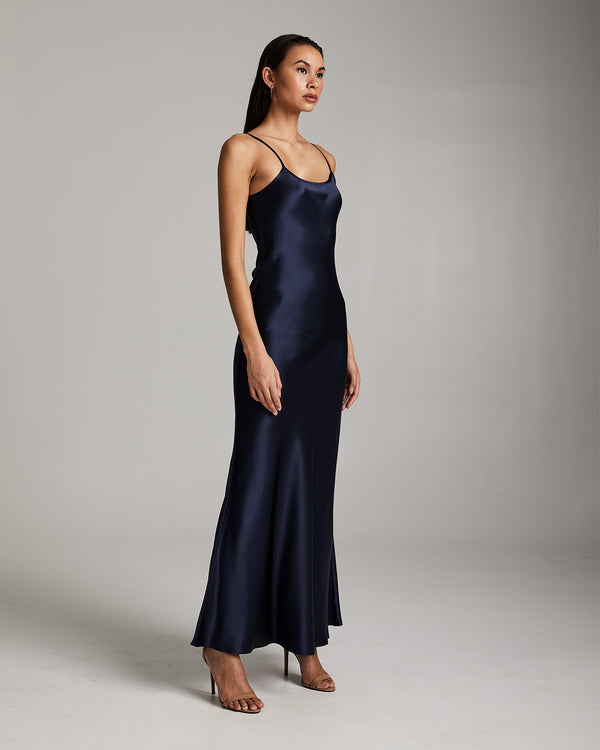 Model wearing a navy Liquid Silk Slipdress, showcasing its elegant design.