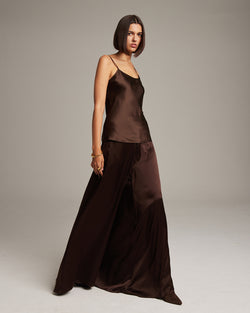 Model wearing a brown silk tank top and palazzo pants