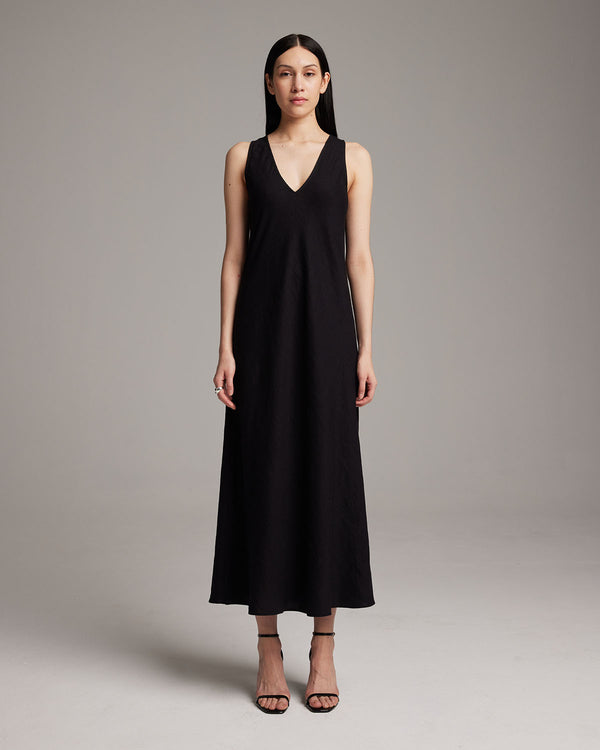 Model wearing a black linen V neck maxi dress
