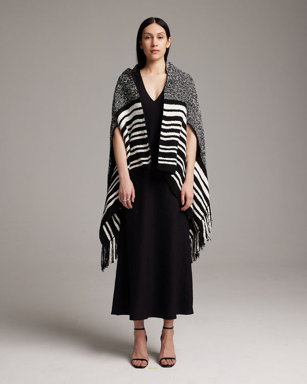 Model wearing a black and white striped Petite Cascade Wrap, standing on a neutral background.