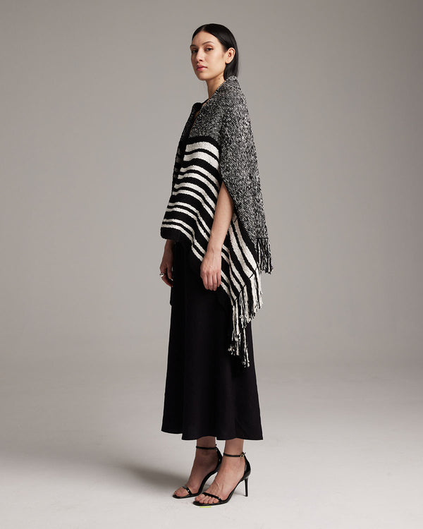 Model wearing a black and white striped Petite Cascade Wrap, standing in profile.