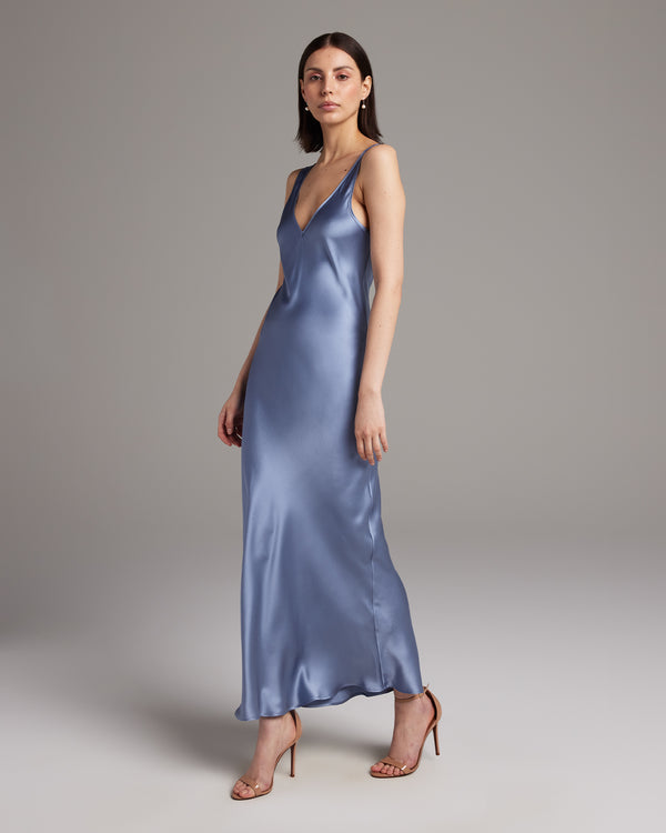 Model wearing a silver Double V Slip Dress in silk charmeuse, showcasing a V-neck design.