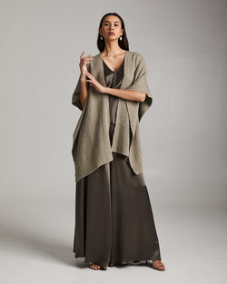 Model wearing a solid fine flammé cotton duster over a long dress in a neutral color.